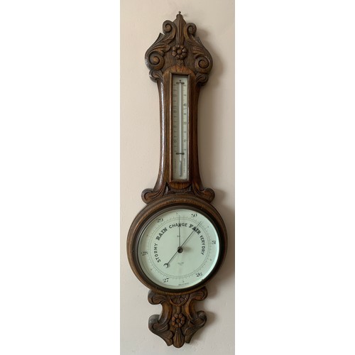 679 - An early 20thc oak cased aneroid barometer with thermometer to stem. Proust Bros. Opticians Hull.