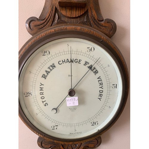 679 - An early 20thc oak cased aneroid barometer with thermometer to stem. Proust Bros. Opticians Hull.