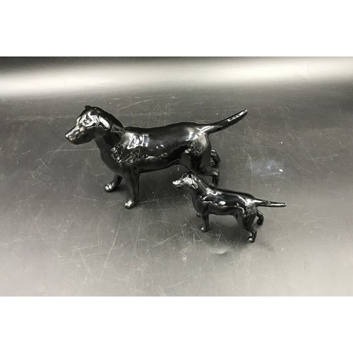 143 - Two Beswick black Labrador dogs one large 13.5cms h and one small 8cms h.