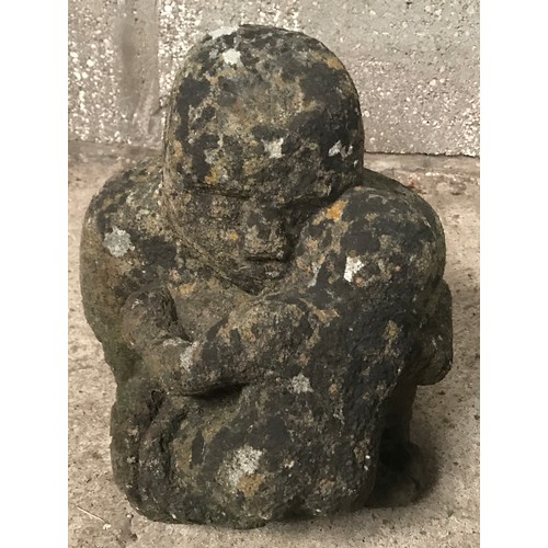 1320 - A stone figure of a man and child. Approx 35cms h x 30cms w.