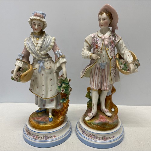 134 - A pair of 19thC figures, a man and woman both with roses. 30cms h.