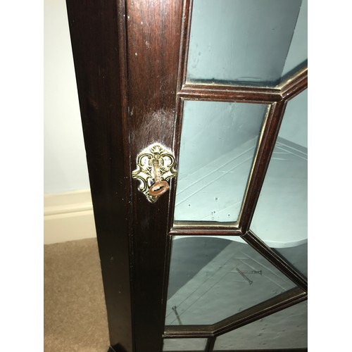 1198 - A good quality astral glazed single door hanging corner cupboard with decorative brass hinges. 94 h ... 