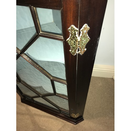 1198 - A good quality astral glazed single door hanging corner cupboard with decorative brass hinges. 94 h ... 