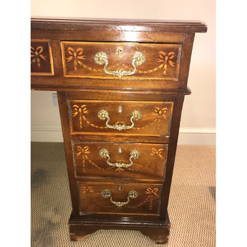 1210 - An Edwardian mahogany inlaid kneehole desk with garland and string inlay. 134 x 68 x 75cms h.