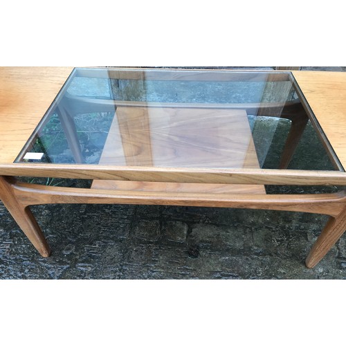 1233 - A G Plan teak coffee table with a central glass inlay panel, with undershelf. 137cms l x 51cms d x 4... 