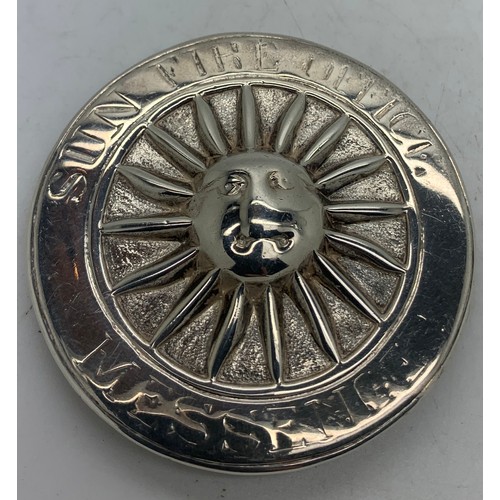 517 - A silver Sun Fire Office fireman's badge, the circular badge with central sun motif, the border insc... 