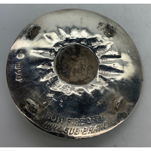 517 - A silver Sun Fire Office fireman's badge, the circular badge with central sun motif, the border insc... 