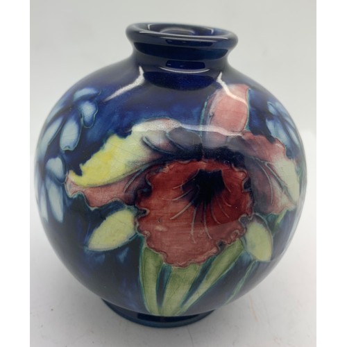 77 - Moorcroft vase, 11.5cms h, blue ground Iris pattern.