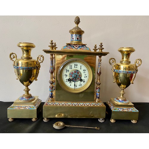 657 - A French brass and enamel clock garniture with enamelled pillars to each corner. 35cms h, candlestic... 