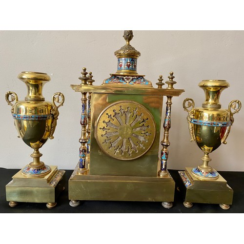 657 - A French brass and enamel clock garniture with enamelled pillars to each corner. 35cms h, candlestic... 