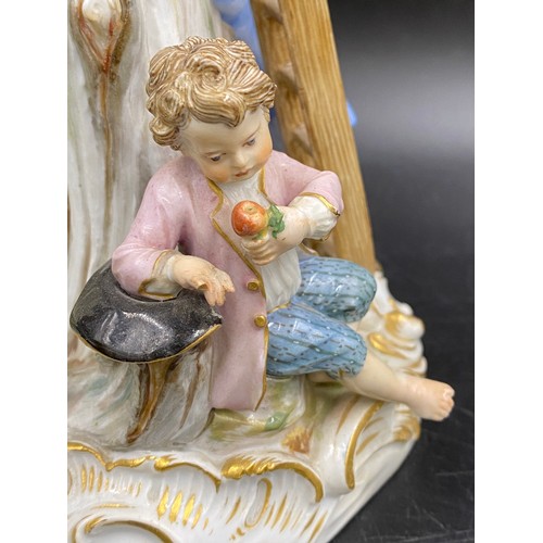 69 - A Meissen figurine group of apple pickers depicting a boy in a tree picking apples, a lady and gent ... 