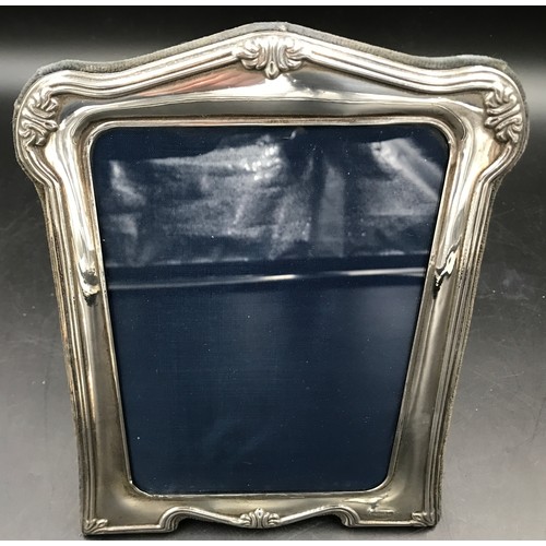 541 - Three hallmarked silver photo frames. Largest Sheffield 1996 24cms h x 18cms w, floral embossed stam... 