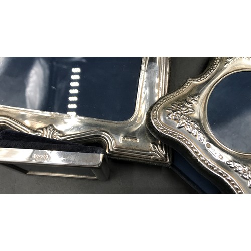 541 - Three hallmarked silver photo frames. Largest Sheffield 1996 24cms h x 18cms w, floral embossed stam... 