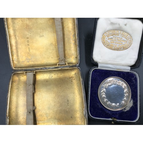 542 - A silver cigarette box Birmingham WHS 191 88gms, a silver swimming medal 25gms with case together wi... 