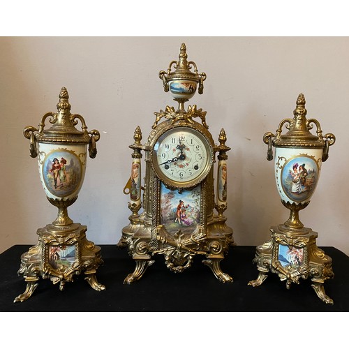 660 - A 20thC decorative French brass and ceramic clock garniture. Clock 42cms h, vase 33cms h.