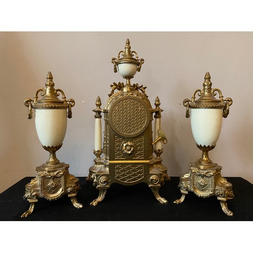 660 - A 20thC decorative French brass and ceramic clock garniture. Clock 42cms h, vase 33cms h.