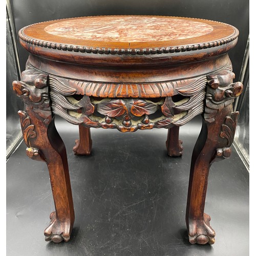 1217 - A Chinese carved hardwood stand with a circular top and marble inlay. 46cms h x 46cms w.