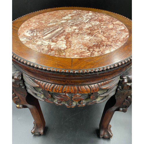 1217 - A Chinese carved hardwood stand with a circular top and marble inlay. 46cms h x 46cms w.