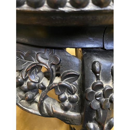 1218 - A Chinese carved hardwood circular stand with marble inlay and floral carving.