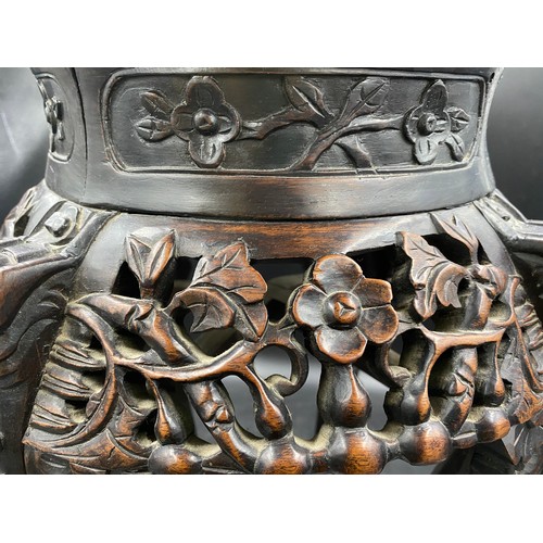 1219 - A Chinese carved hardwood stand with floral carving and marble inlay to the top. Width at feet 37cms... 