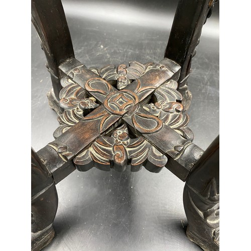 1219 - A Chinese carved hardwood stand with floral carving and marble inlay to the top. Width at feet 37cms... 