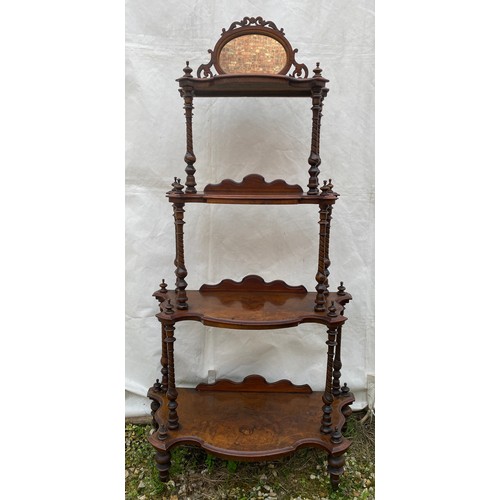 1220 - A Victorian walnut four tier graduating what-not with oval mirror and string inlay. On castors. 76cm... 