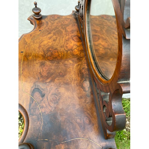 1220 - A Victorian walnut four tier graduating what-not with oval mirror and string inlay. On castors. 76cm... 