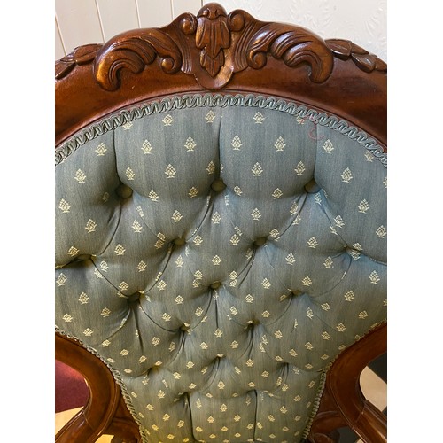 1222 - A Victorian mahogany framed button upholstered armchair with carved back. Height to seat 38cms, heig... 