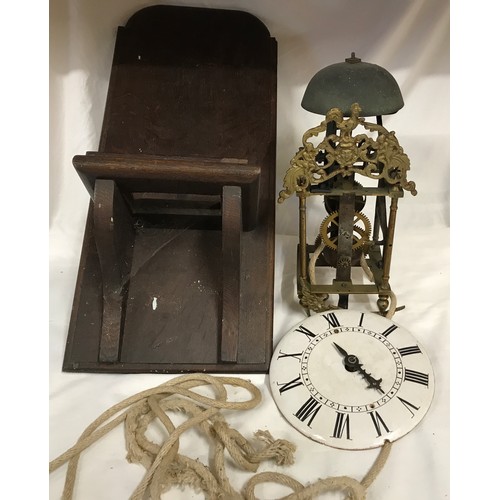 661 - A 19thC brass framed lantern clock for restoration, enamel dial with an oak wall mounted bracket she... 