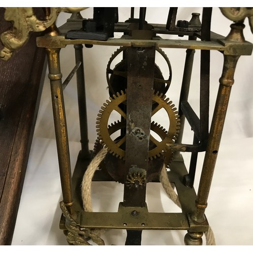 661 - A 19thC brass framed lantern clock for restoration, enamel dial with an oak wall mounted bracket she... 