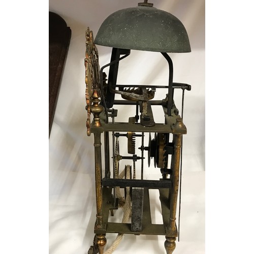 661 - A 19thC brass framed lantern clock for restoration, enamel dial with an oak wall mounted bracket she... 