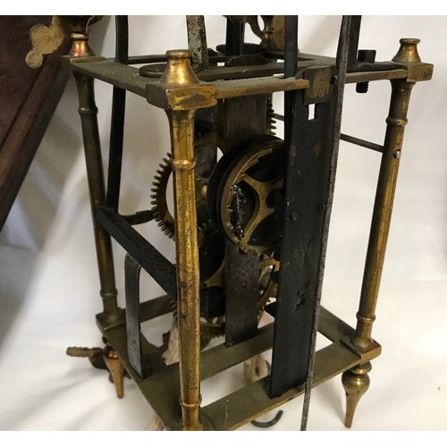 661 - A 19thC brass framed lantern clock for restoration, enamel dial with an oak wall mounted bracket she... 