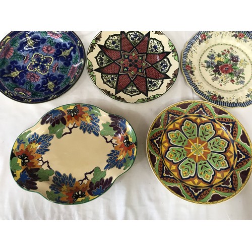 102 - A collection of Royal Doulton decorative plates. Eight approx. 26cms d, one dish 