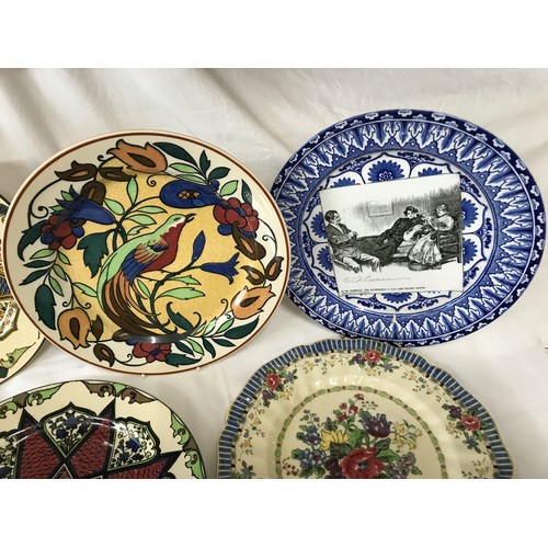 102 - A collection of Royal Doulton decorative plates. Eight approx. 26cms d, one dish 