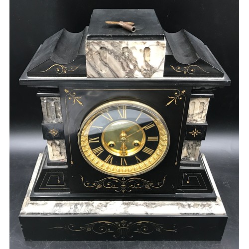 662 - A slate and marble mantle clock with brass face, Roman numerals and 10cms face dial. Ht 35cms x 34cm... 