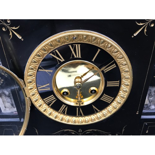 662 - A slate and marble mantle clock with brass face, Roman numerals and 10cms face dial. Ht 35cms x 34cm... 