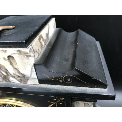 662 - A slate and marble mantle clock with brass face, Roman numerals and 10cms face dial. Ht 35cms x 34cm... 