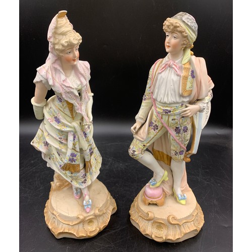 98 - A pair of Continental bisque porcelain figures of a gentleman and lady. 33cms h to base.