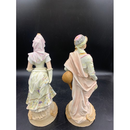 98 - A pair of Continental bisque porcelain figures of a gentleman and lady. 33cms h to base.