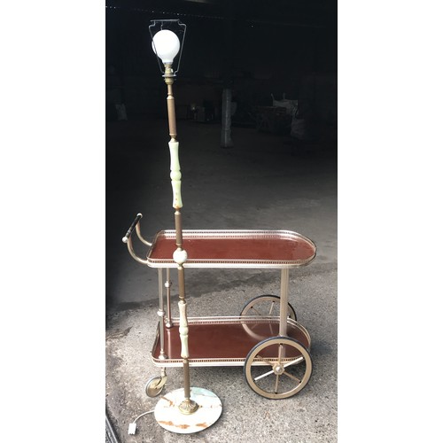 555 - Onyx and brass standard lamp 148cms h and a brass effect two tier serving tea trolley.