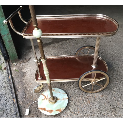 555 - Onyx and brass standard lamp 148cms h and a brass effect two tier serving tea trolley.