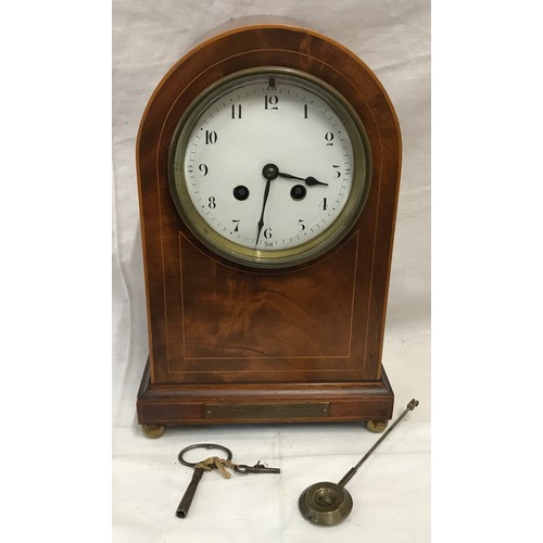 670 - An Edwardian inlaid mahogany mantle clock with enamel face, Arabic numerals and French made movement... 