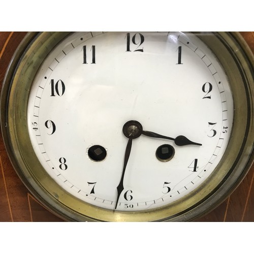 670 - An Edwardian inlaid mahogany mantle clock with enamel face, Arabic numerals and French made movement... 