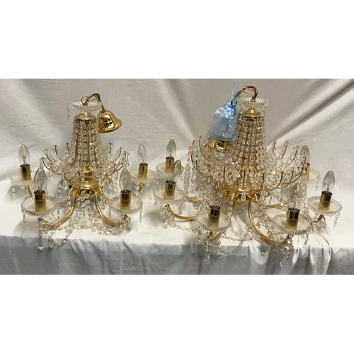 549 - Two glass droplet and brass ceiling light chandeliers. Largest 8 branch approx. 60cms w, height to c... 