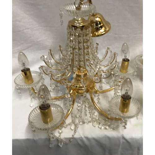 549 - Two glass droplet and brass ceiling light chandeliers. Largest 8 branch approx. 60cms w, height to c... 