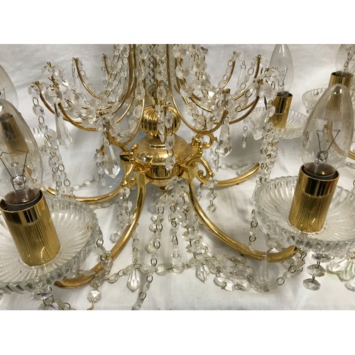 549 - Two glass droplet and brass ceiling light chandeliers. Largest 8 branch approx. 60cms w, height to c... 