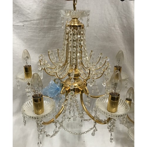 549 - Two glass droplet and brass ceiling light chandeliers. Largest 8 branch approx. 60cms w, height to c... 