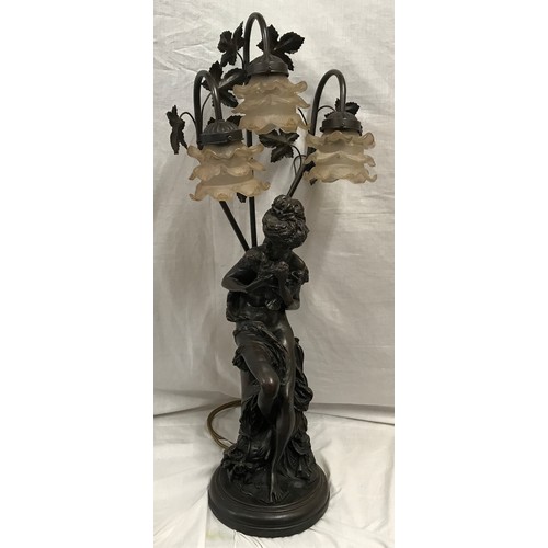 554 - A large bronze effect figural table lamp with 3 branch floral glass light shades. Approx. 82cms over... 