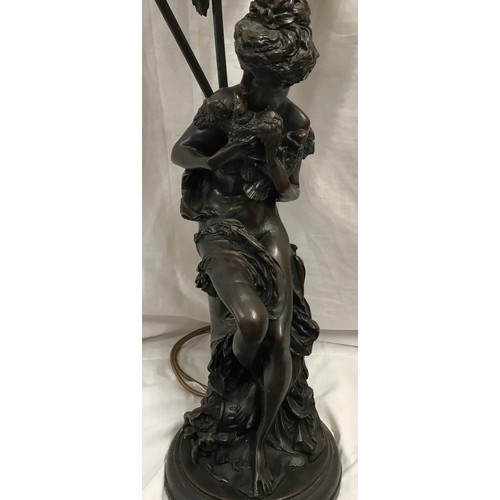 554 - A large bronze effect figural table lamp with 3 branch floral glass light shades. Approx. 82cms over... 