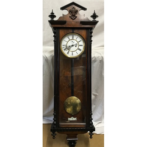 667 - A walnut veneered pendulum wall clock with enamel face and Roman numerals. Case measures approx. 122... 